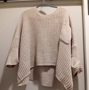 Cropped warm sweater.  Thick material , cream colored . Fits a little big. L/XL